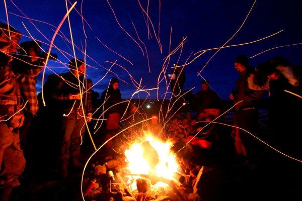 Photo by: Bjorn Olson -  fatbikers and non-fatbikers alike gather at the Friday night Meet-and-Greet bonfire