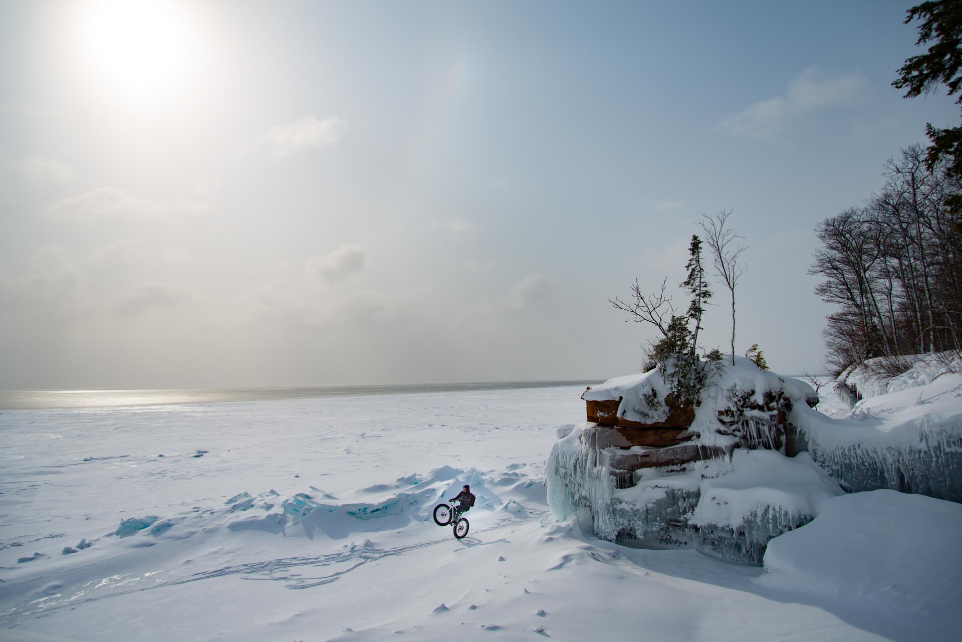 Man riding a wheelie on frozen Lake Superior