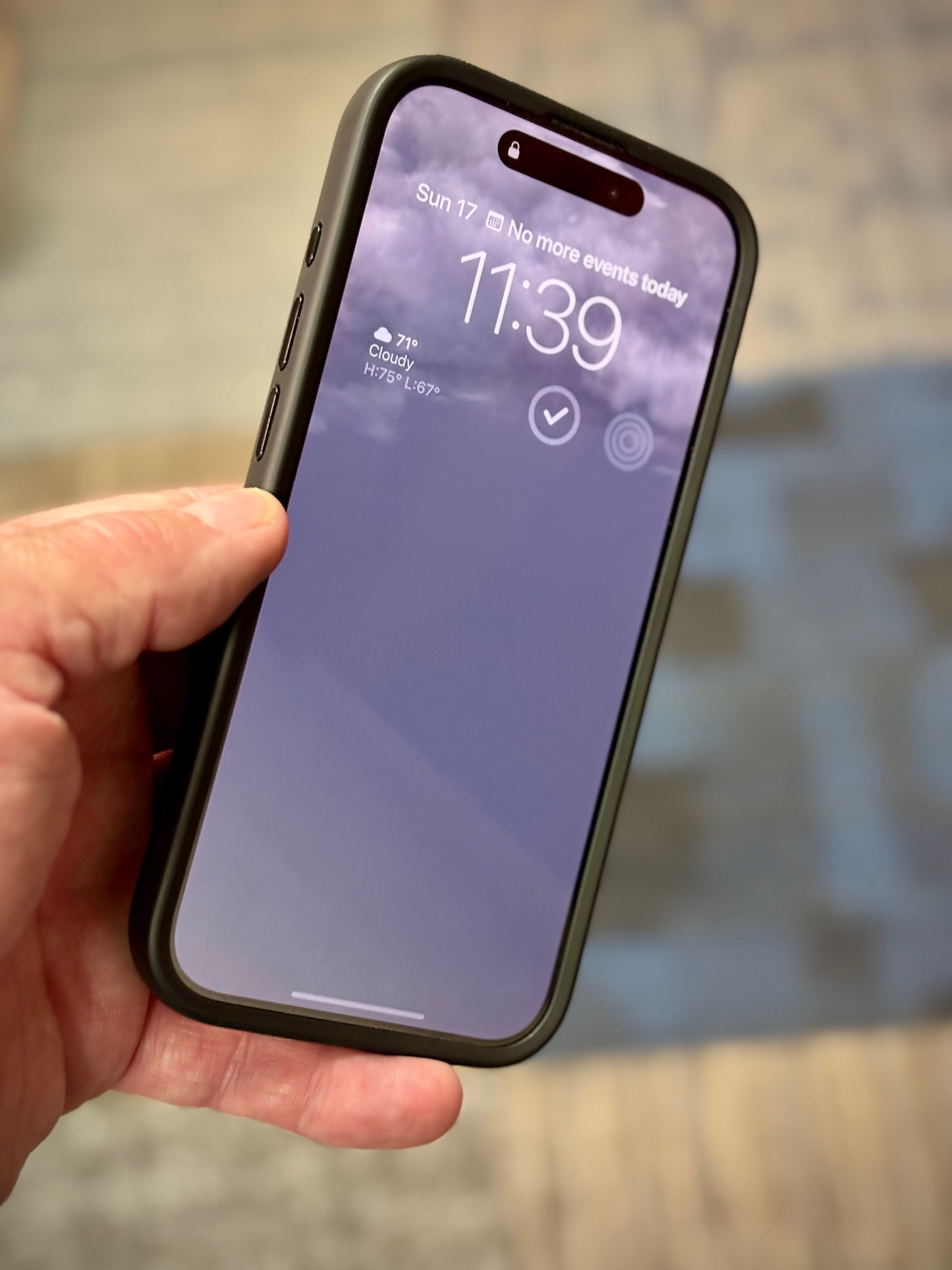 Quad Lock MAG Case installed on iPhone 15 Pro showing deep front lip for added screen protection.